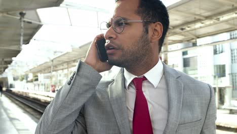 Serious-businessman-talking-by-cell-phone